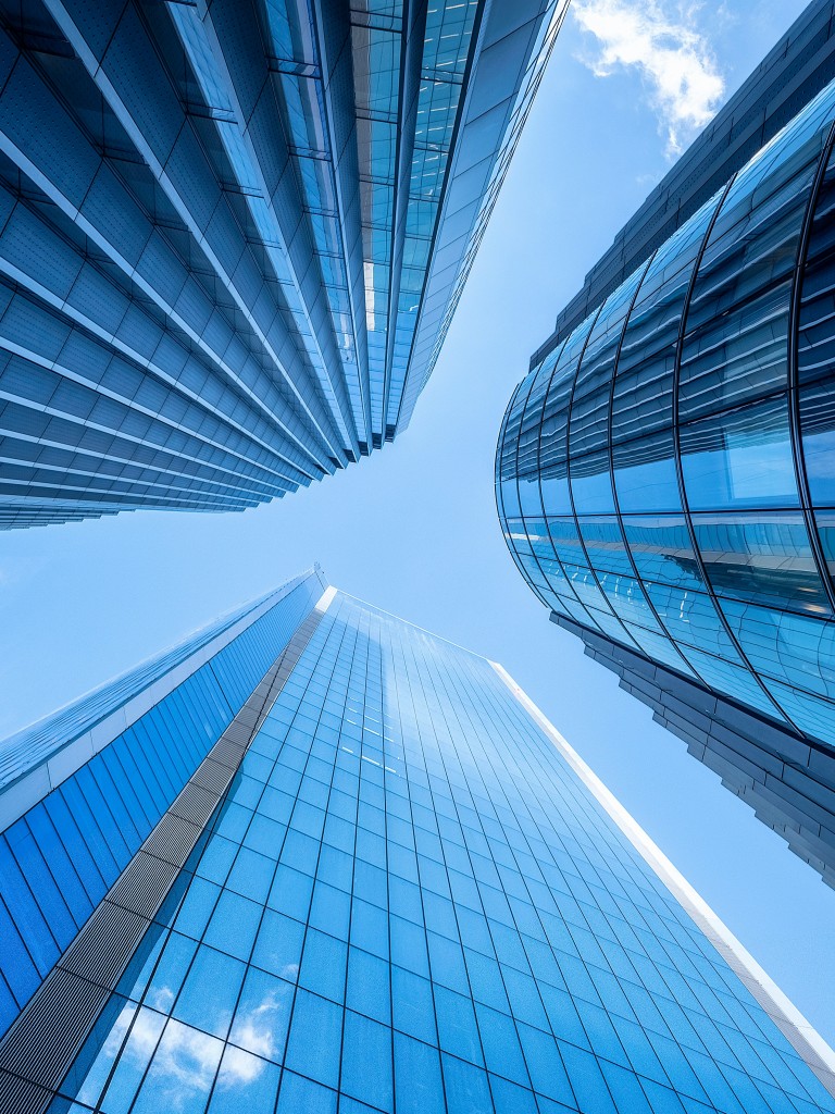a very tall building with a sky in the background by william warby on unsplash